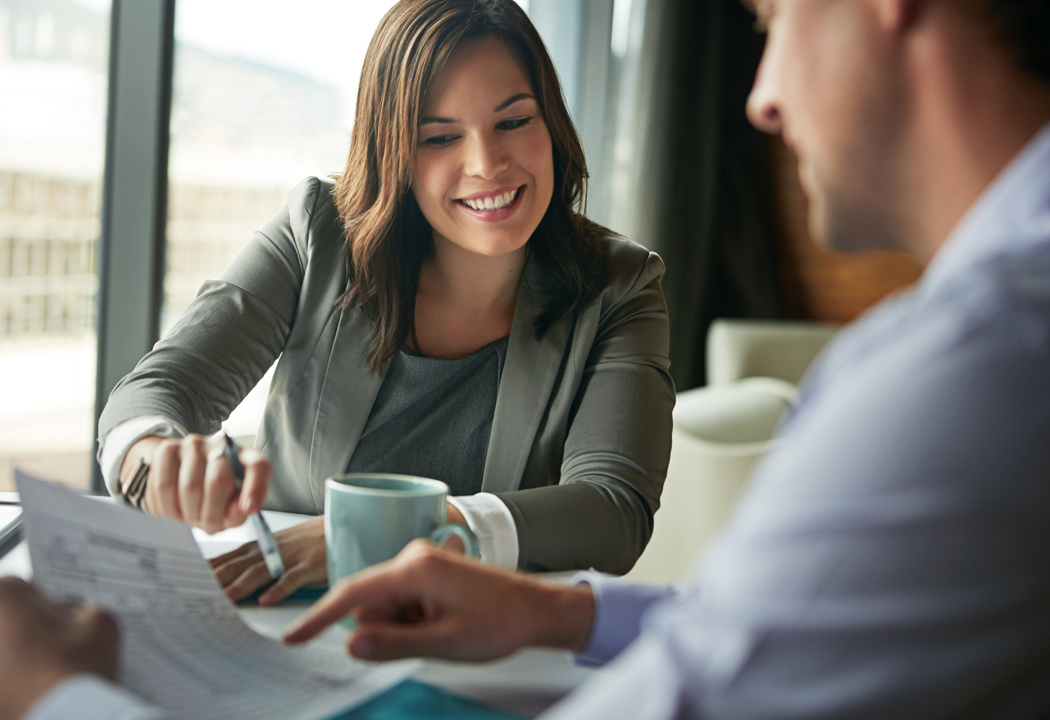 Photo of a banker discussing options with a client. Primary Bank is NH's Bank for Business!